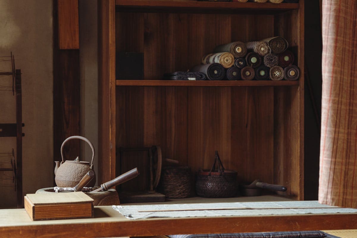 Rolled textiles and an iron kettle in a craft workshop