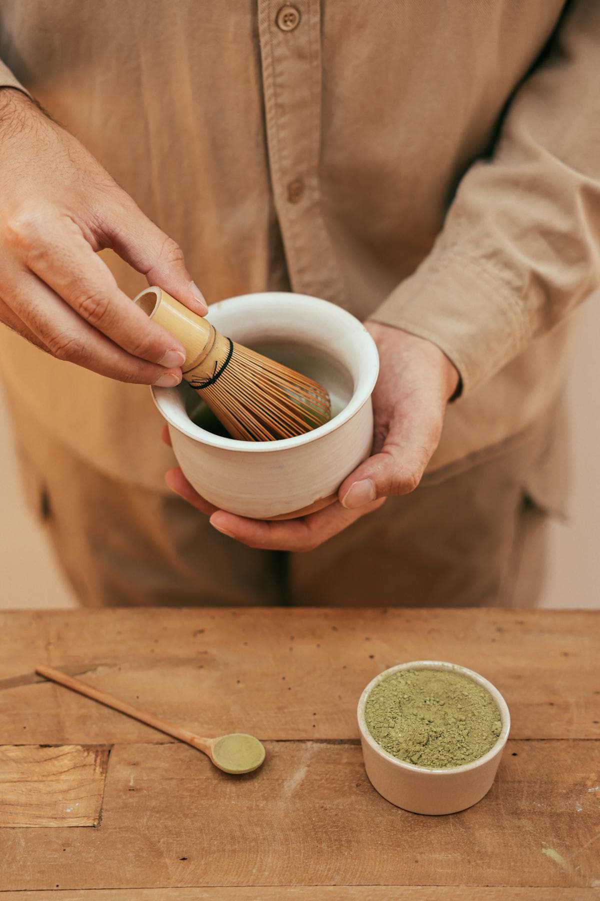 Whisking matcha tea with a bamboo whisk
